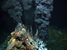 Deep-sea hydrothermal vent  Credits: MARUM − Zentrum für Marine Umweltwissenschaften, Universität Bremen  Caption: Black smoker in 2,980 meters of wa­ter on the Mid-At­lantic Ridge. Some hypotheses suggest that deep-sea hydrothermal vents may have provided favorable conditions for the emergence of early life. In these environments, chemical and energy gradients could have supported primitive chemical systems and metabolic-like processes based on compounds released by hydrothermal activity.